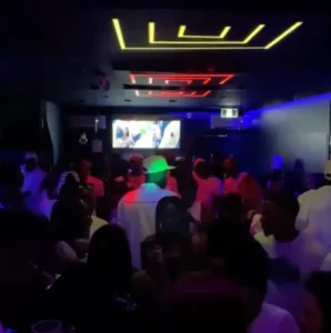 People dancing by the bar