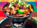 A dish with sizzling meat and veggies